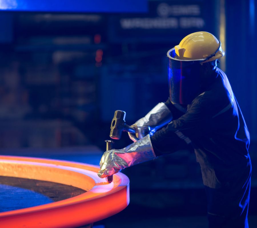 SEForge technician working on a heated steel ring