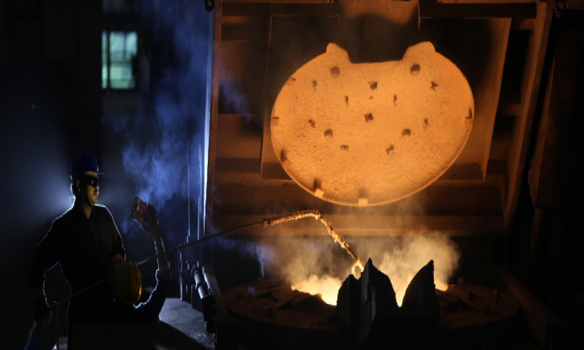 Heated forging emerging from an industrial furnace