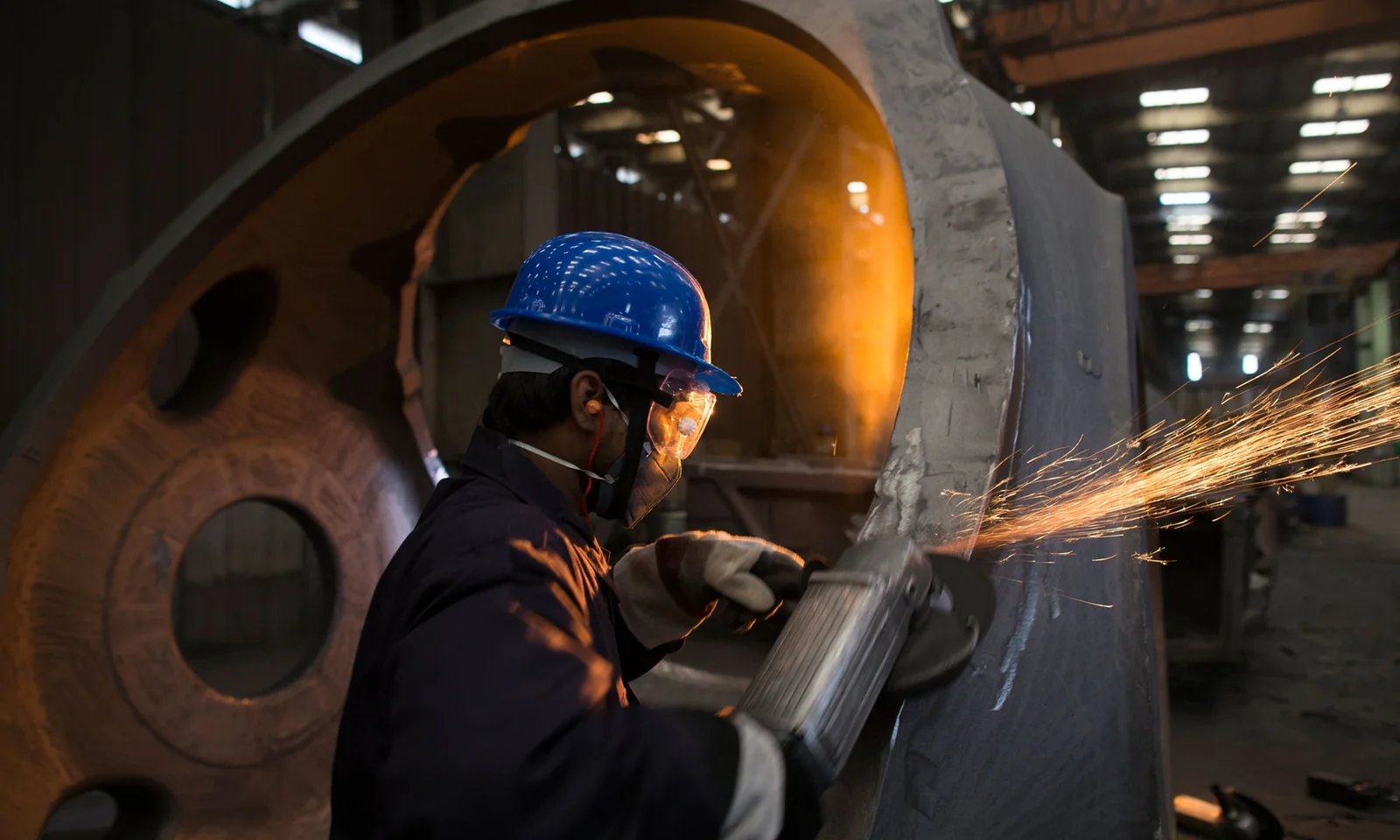 SEForge technician finishing a large industrial casting