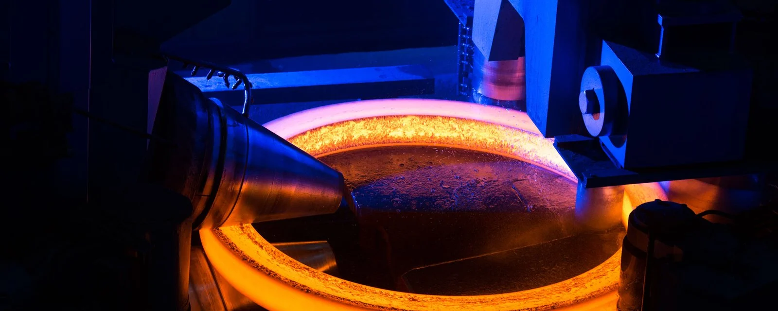 Hot steel ring being shaped by ring-rolling machinery at SEForge
